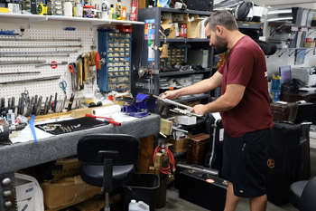 Straightening a trumpet bell.